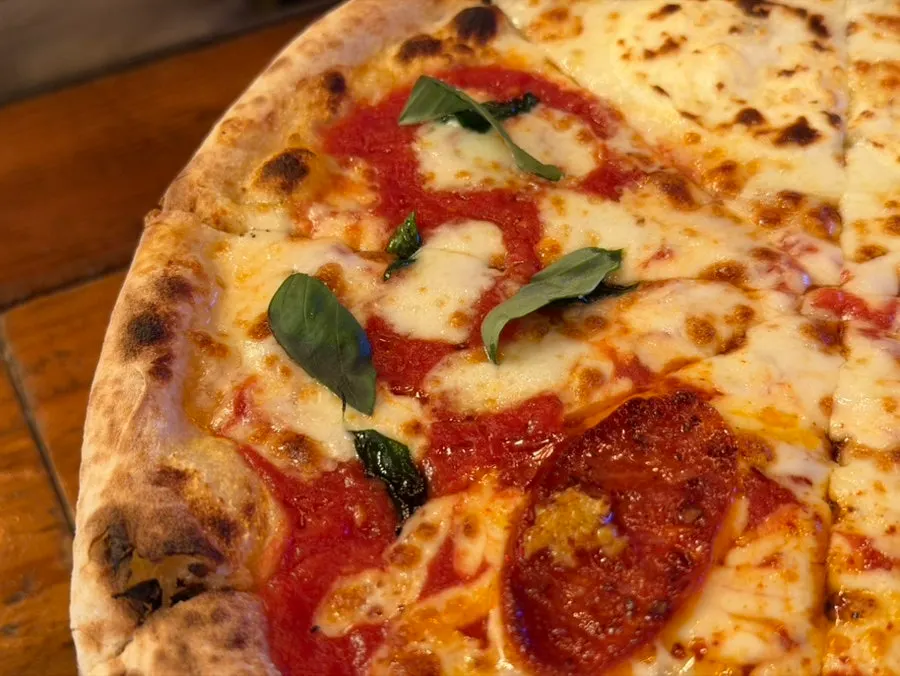 Whole Quattro Stagioni pizza on the table