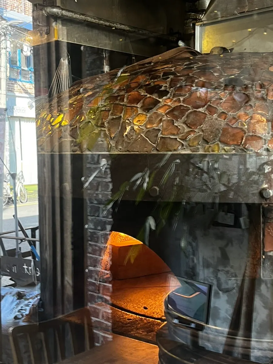 Work station in front of the oven where dough is shaped after ordering