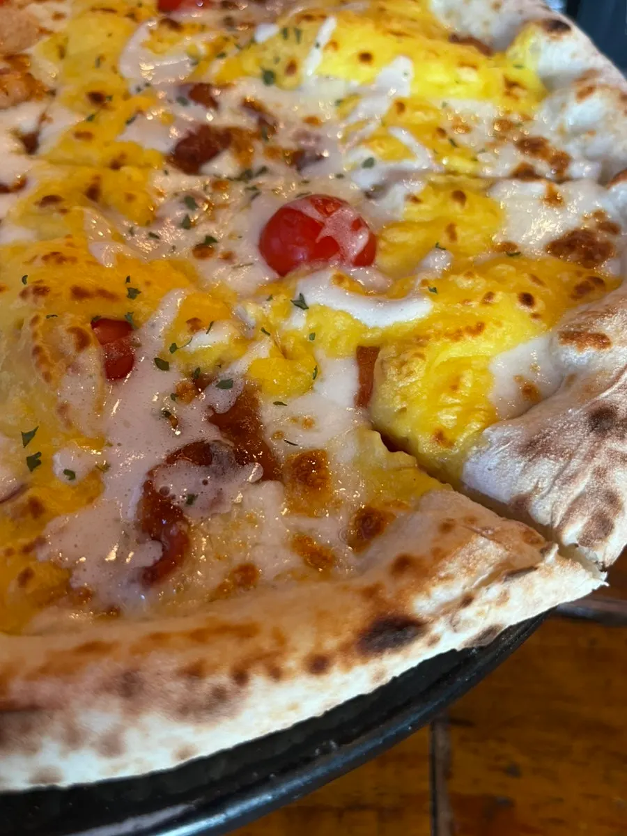 Patata Dolce pizza topped with sweet potato mousse and bacon