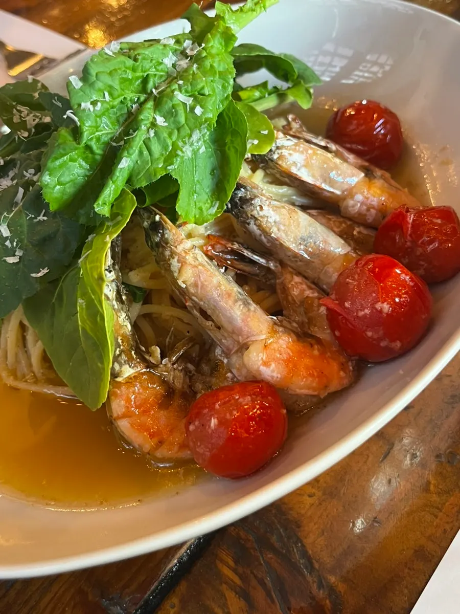 A plate of Gamberi e Rucola pasta piled with ingredients