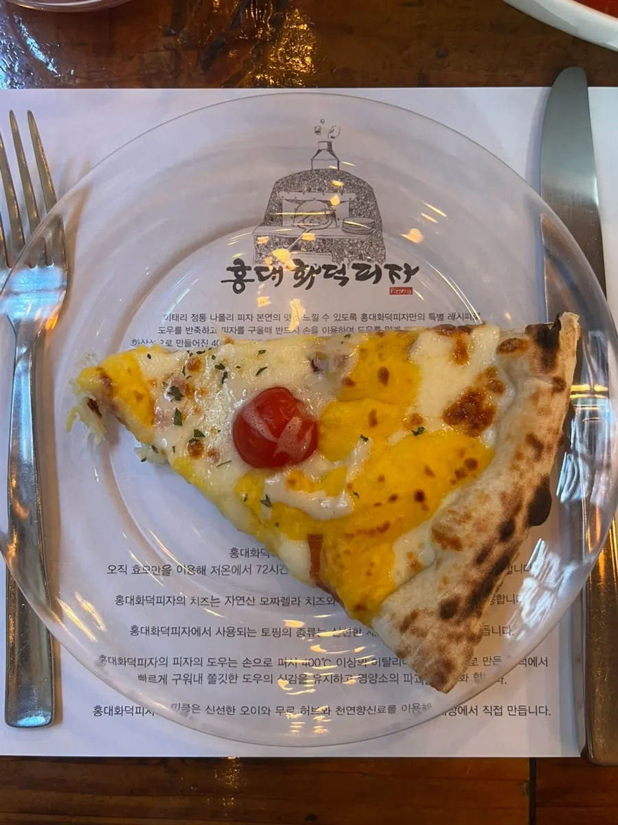 A slice of pizza fresh from the wood-fired oven