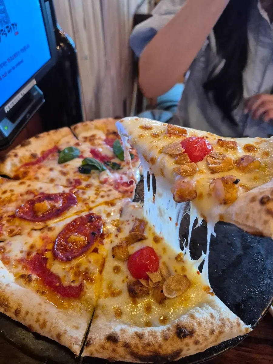 Chewy wood-fired dough edge visible on the crust
