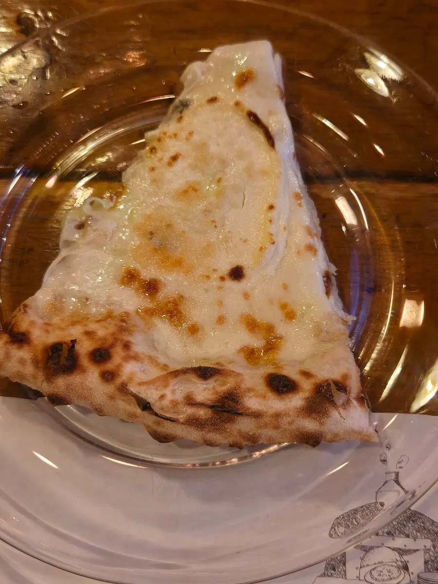 A slice of wood-fired pizza with stretchy cheese