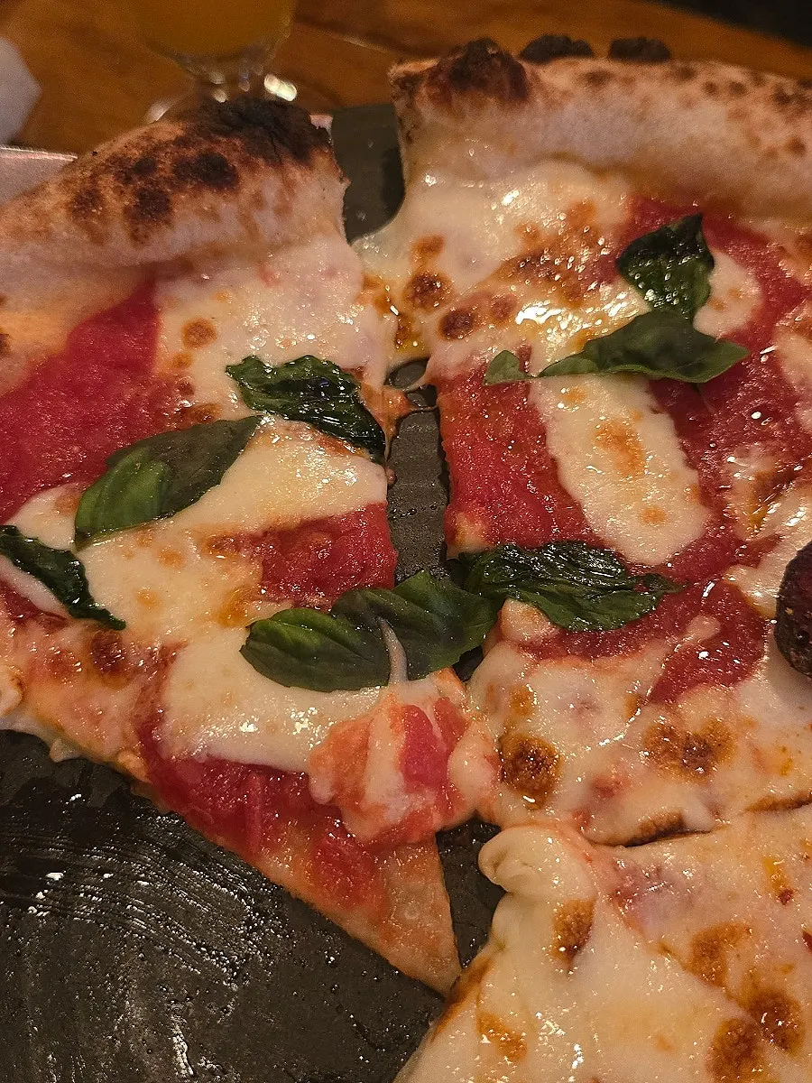 Quattro Formaggi pizza slice dipped in honey