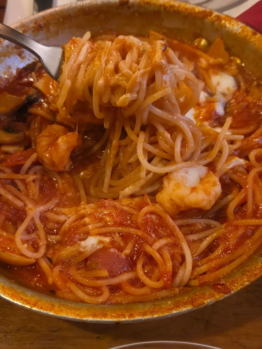 Gamberi Piccante pasta topped with cheese