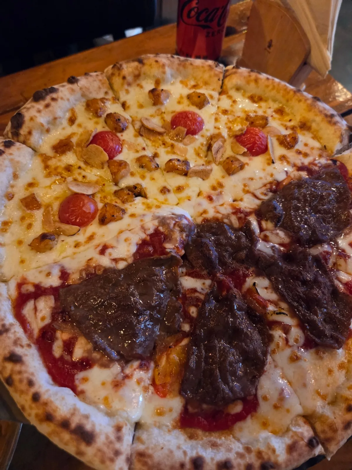 Wood-fired pizza served half Manjo, half Crocante
