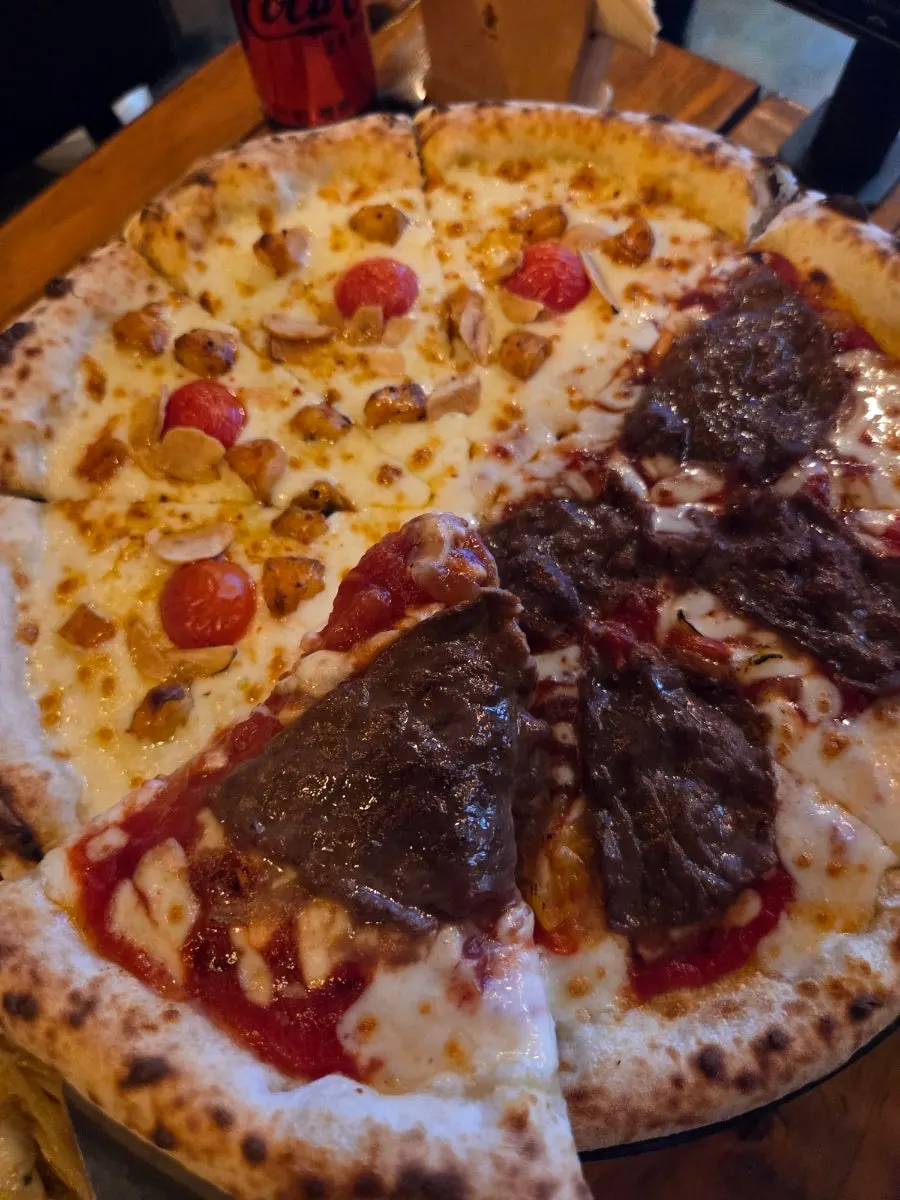 A slice of Manjo pizza topped with beef bulgogi
