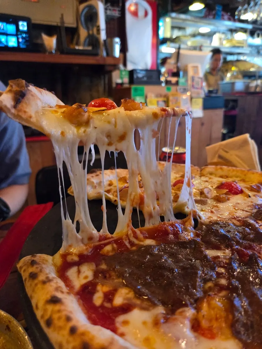 Table set with wood-fired pizza and shrimp cream pasta together