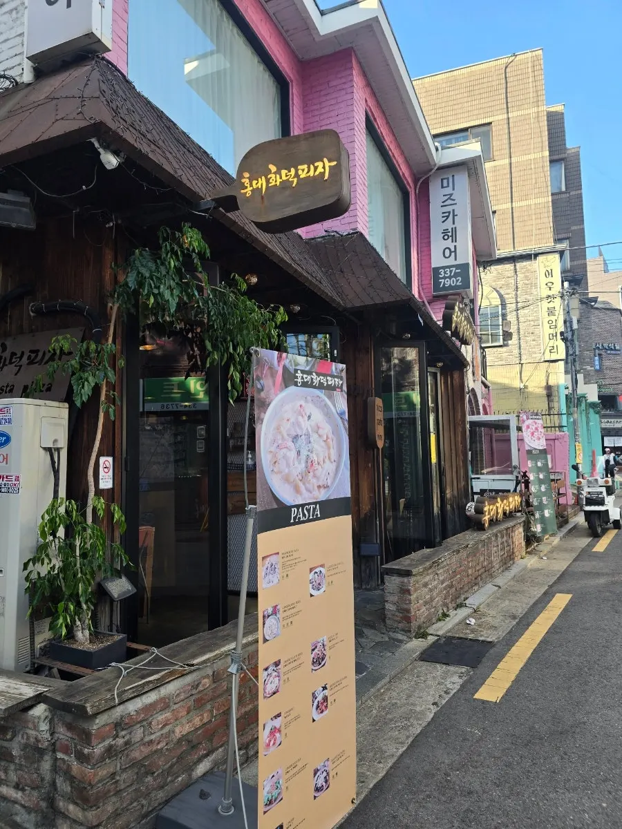 Exterior of Hongdae Hwadeok Pizza in an alley off Dokmak-ro, Hapjeong