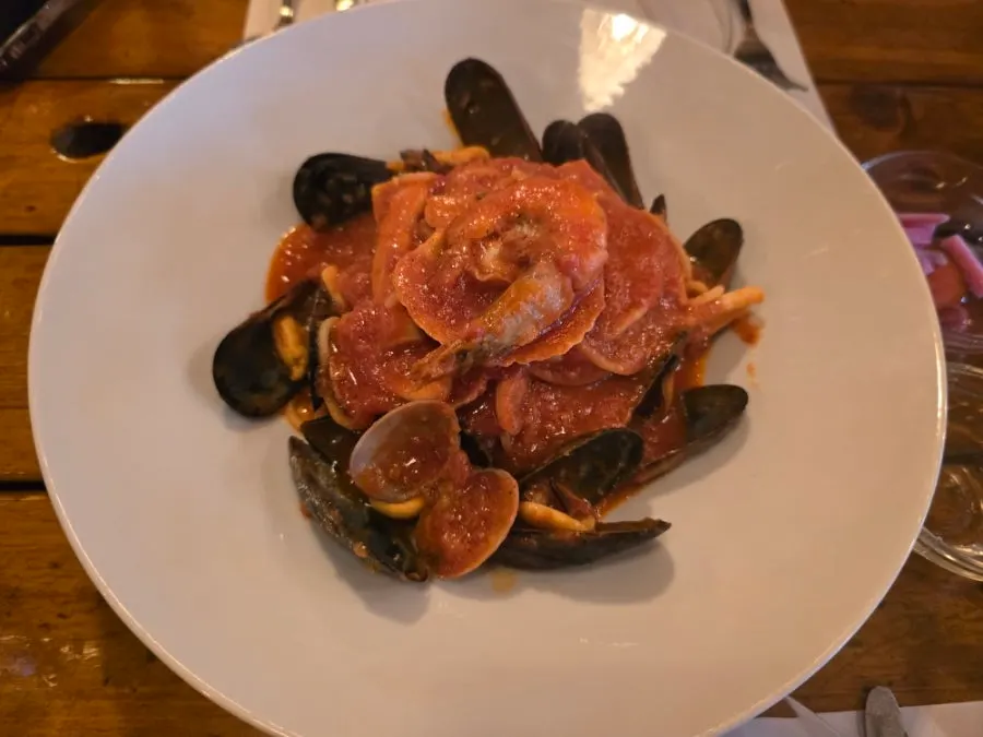 A plate of seafood tomato pasta loaded with seafood