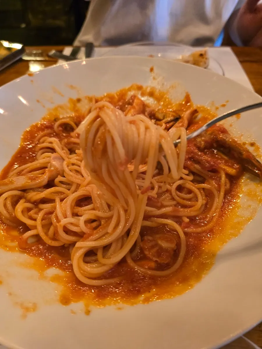 Seafood and tomato sauce mixed together in the pasta