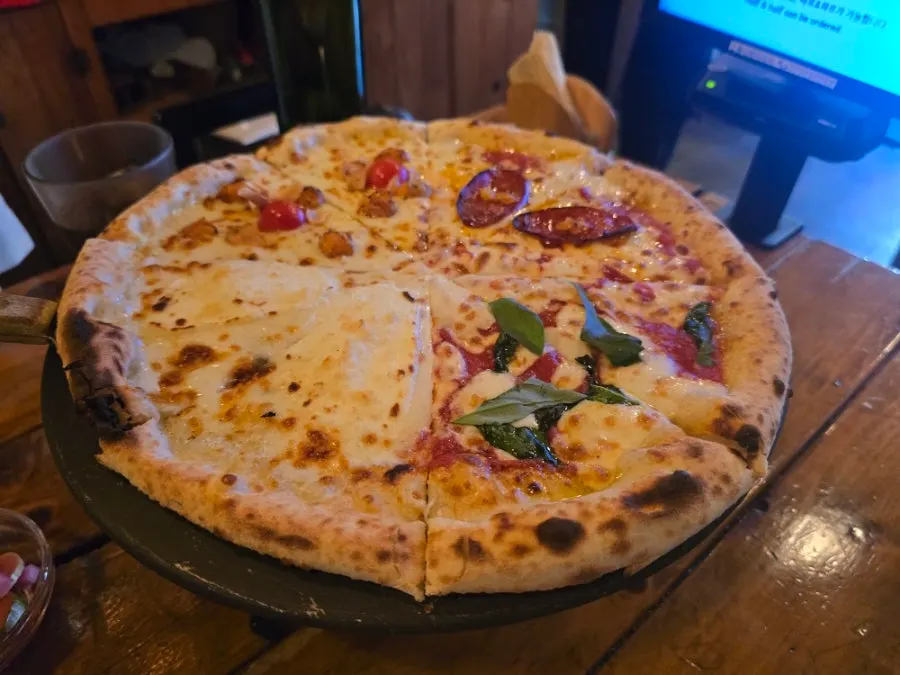 Menu board showing half-and-half and Quattro pizza options