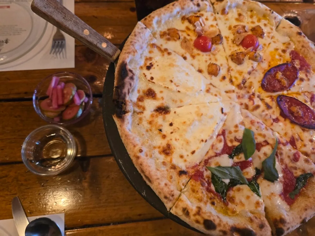 Quattro Stagioni pizza fresh out of the wood-fired oven