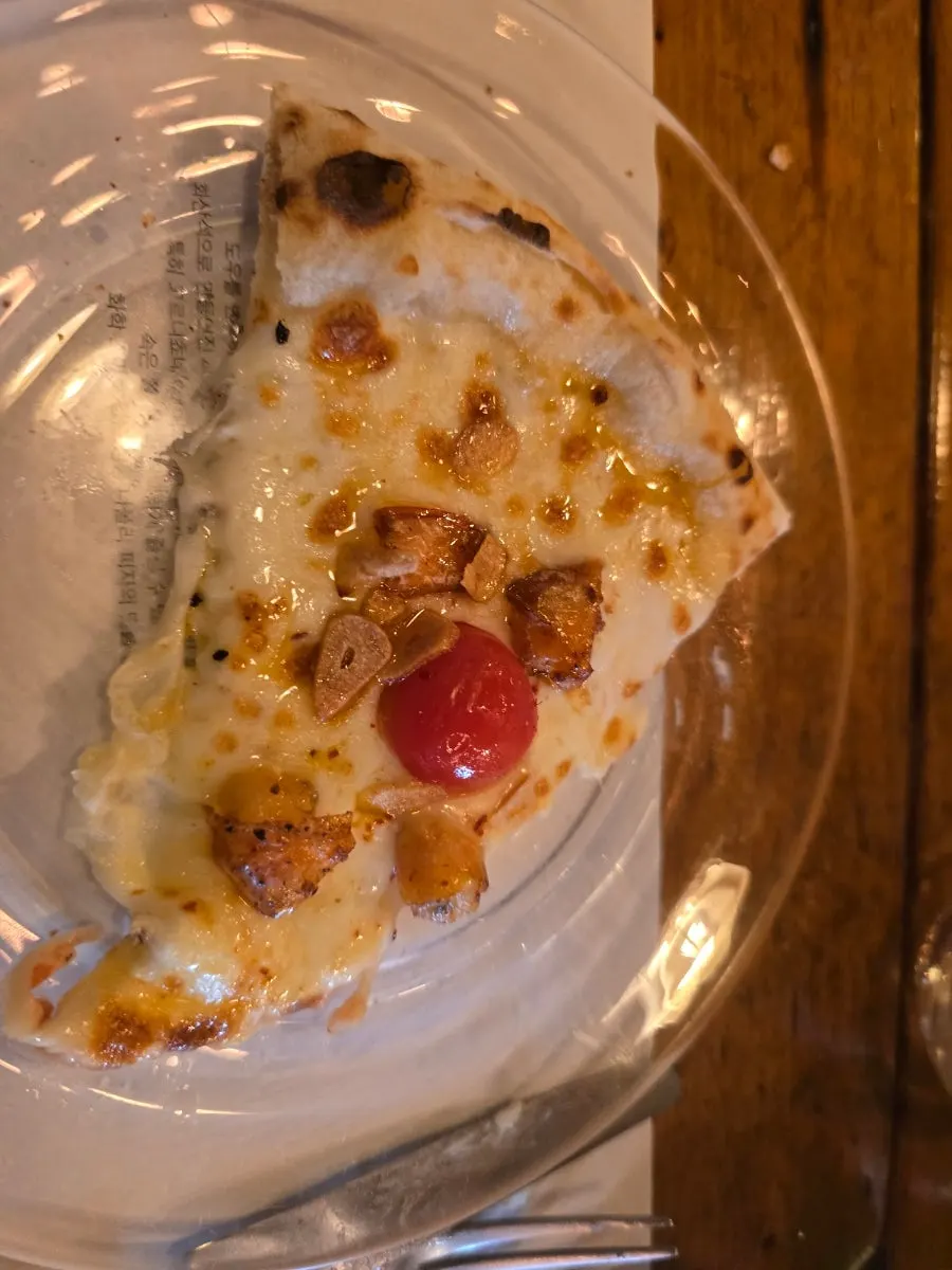 Quattro Formaggi pizza slice served with honey