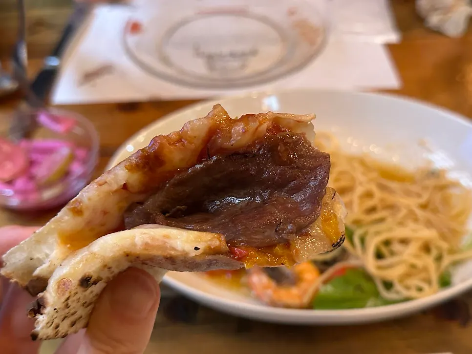 A slice of Manjo pizza lifted up