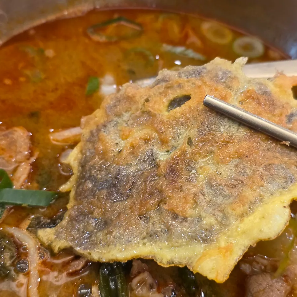 Beef yukjeon cut into rectangles and layered on a plate