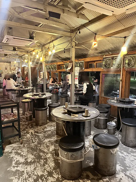 View of the outdoor terrace seating at Gogikkun Gimchunbae Hongdae Supgil Branch