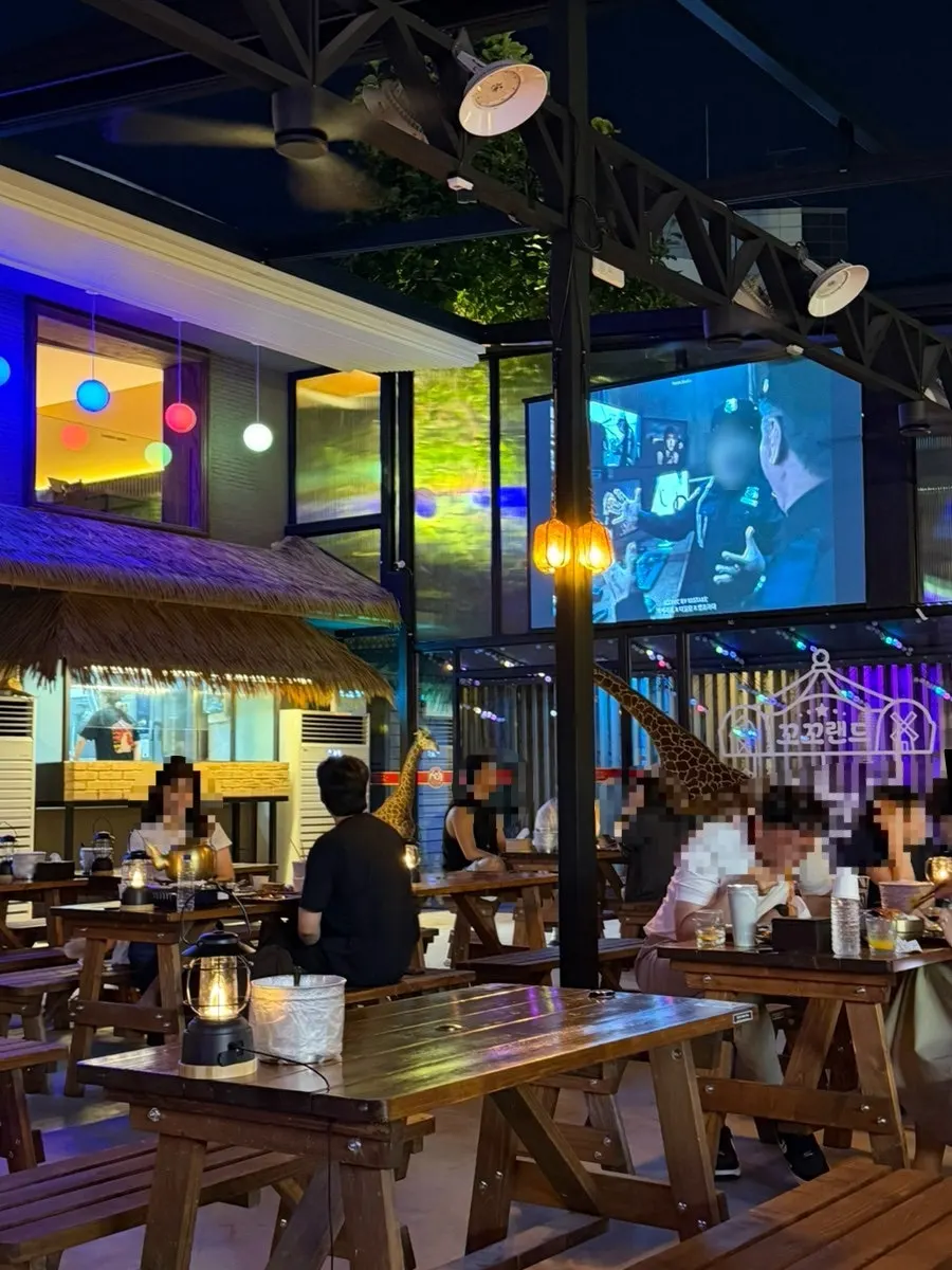 Outdoor space with large screens on both sides
