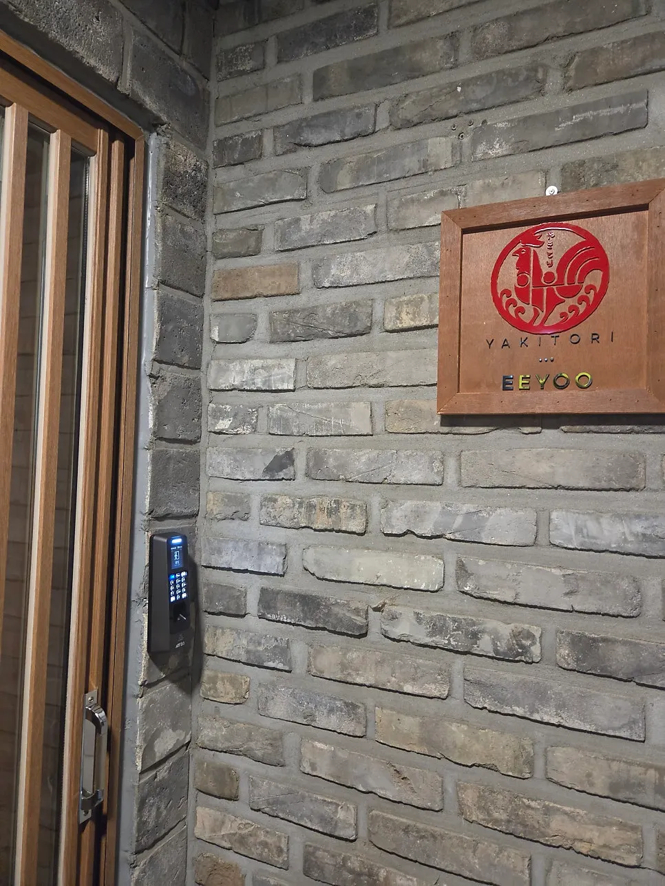 Standing signboard with the signature menu at the entrance of Yakitori Iyu