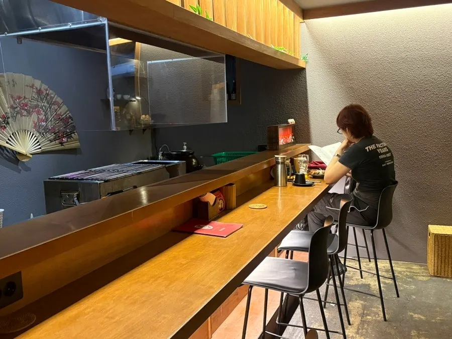 Window seat and table setting at Yakitori Iyu