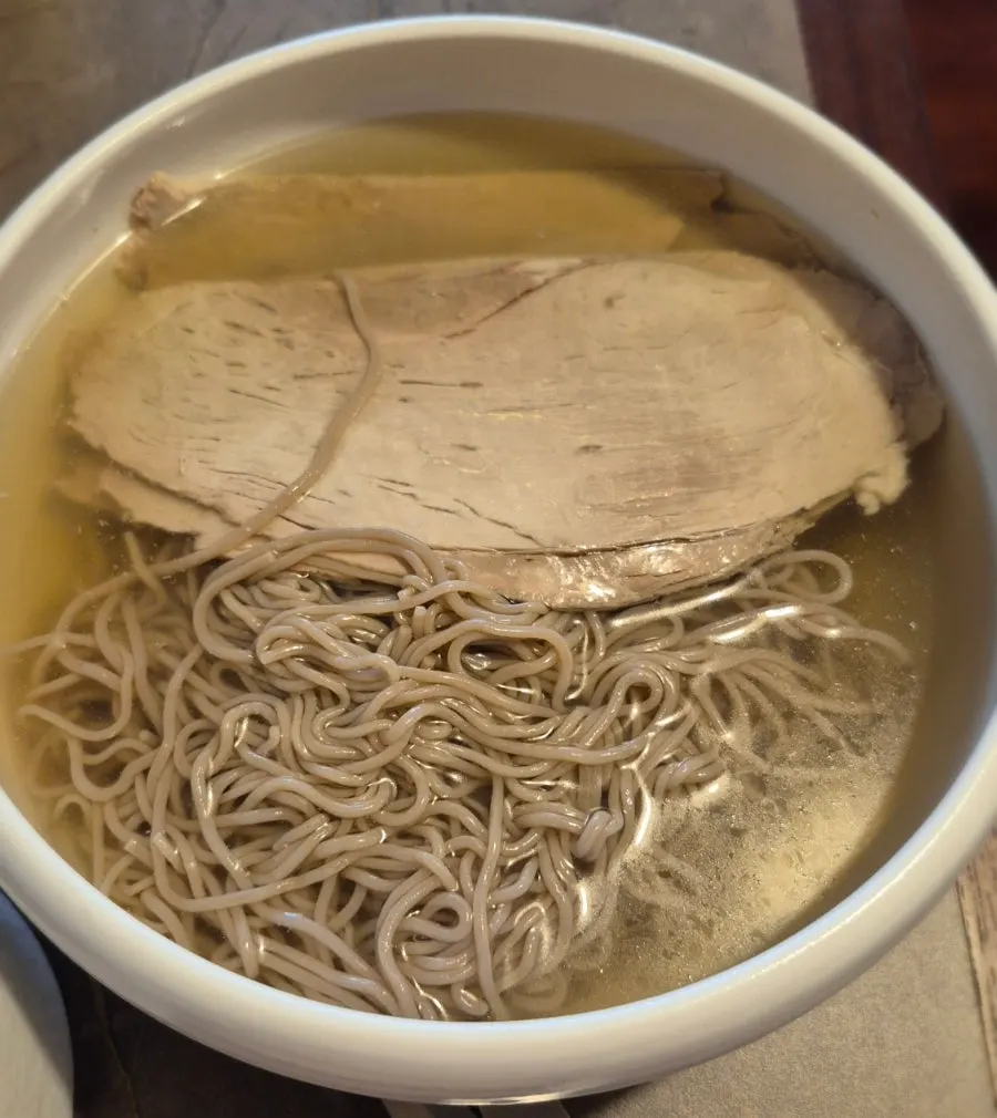 Water-style Pyongyang naengmyeon topped with pyeonyuk