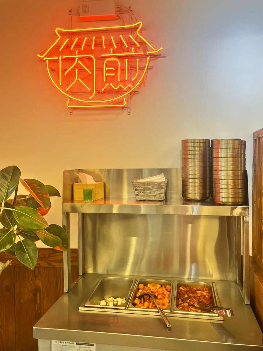 Wooden tables inside, seen through the glass front