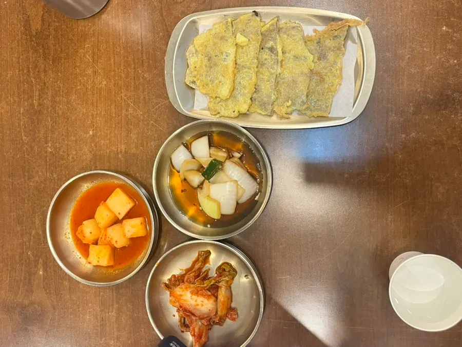 Banchan set of kkakdugi, napa cabbage kimchi, and soy pickle