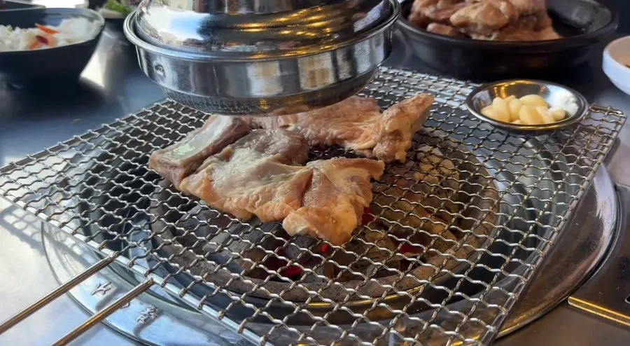 Marinated pork ribs grilling on the charcoal grill