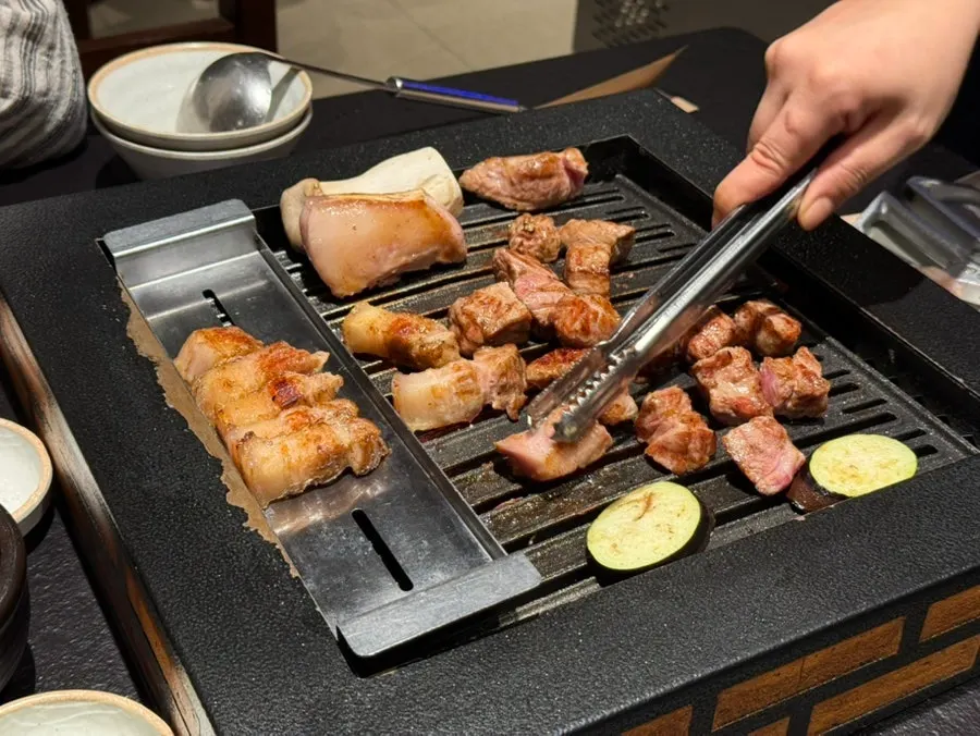 Staff member grilling the meat