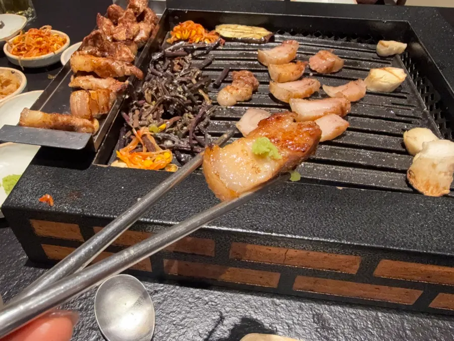 A bite of meat with myeong-i namul and yukjang sauce