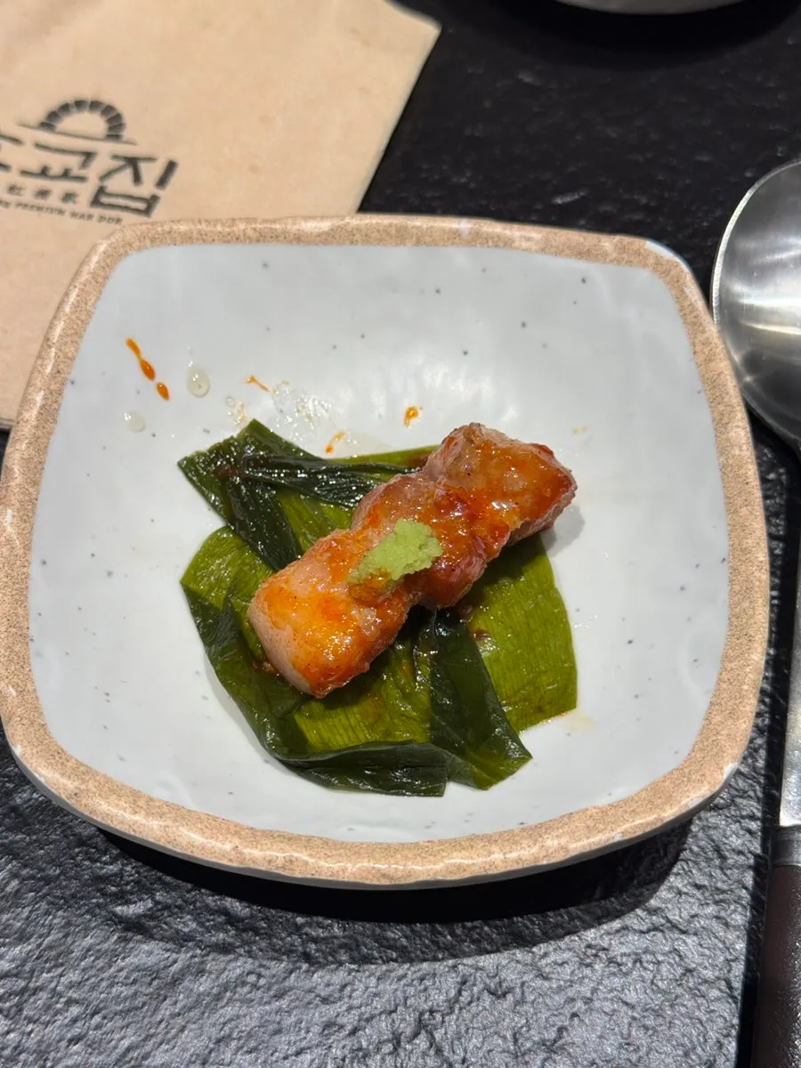 Meat and fruit sauce combination on a wild garlic leaf