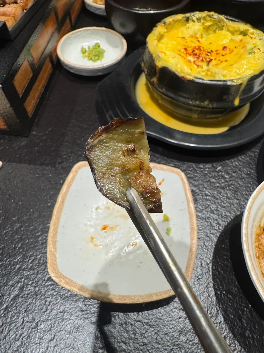 Eating cheese egg custard alongside the grilled meat
