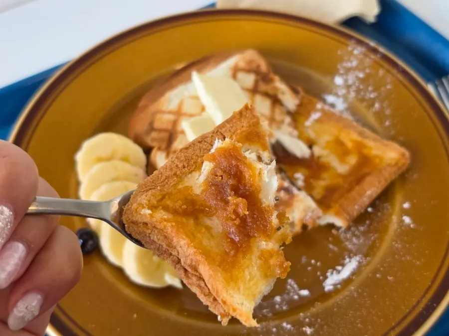 Close-up of a piece of kaya jam toast being picked up