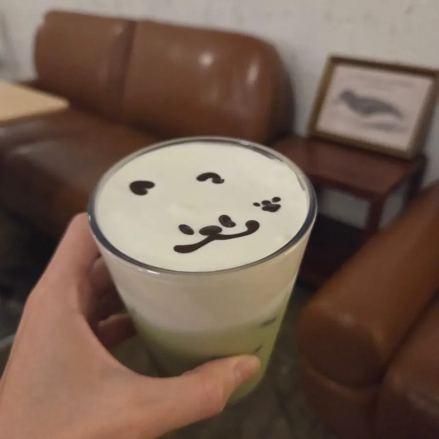 Bear green tea cream latte with a face art design on top