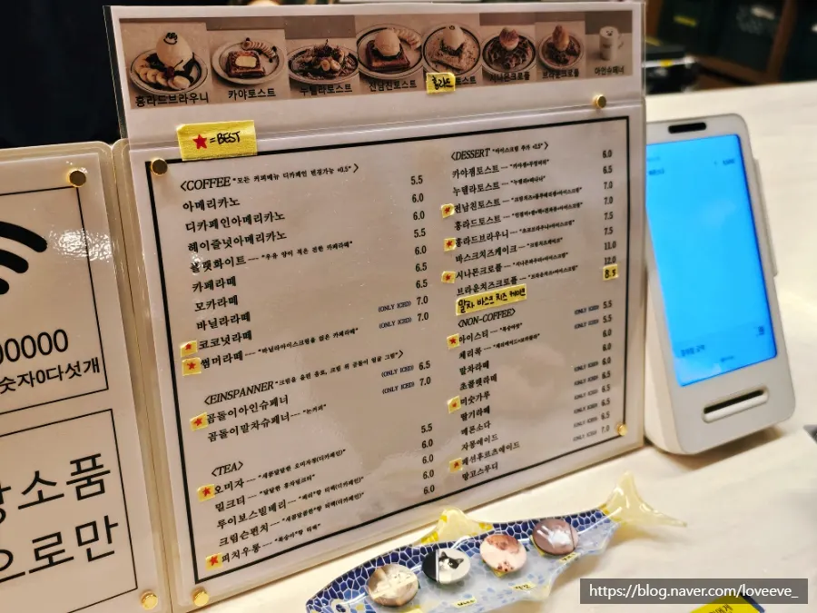 Menu board with coffee and desserts at Hongrad Mangpo Station Branch