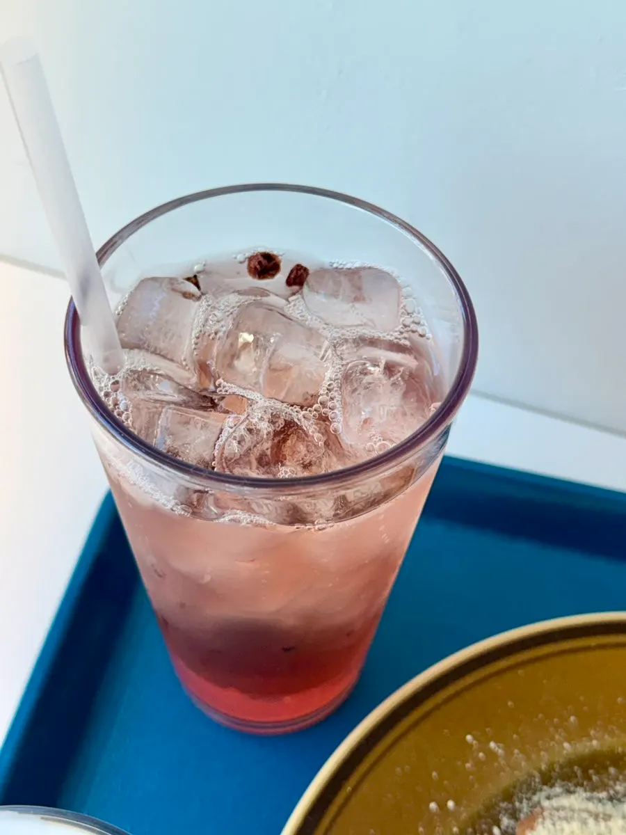 A cold glass of omija tea with ice