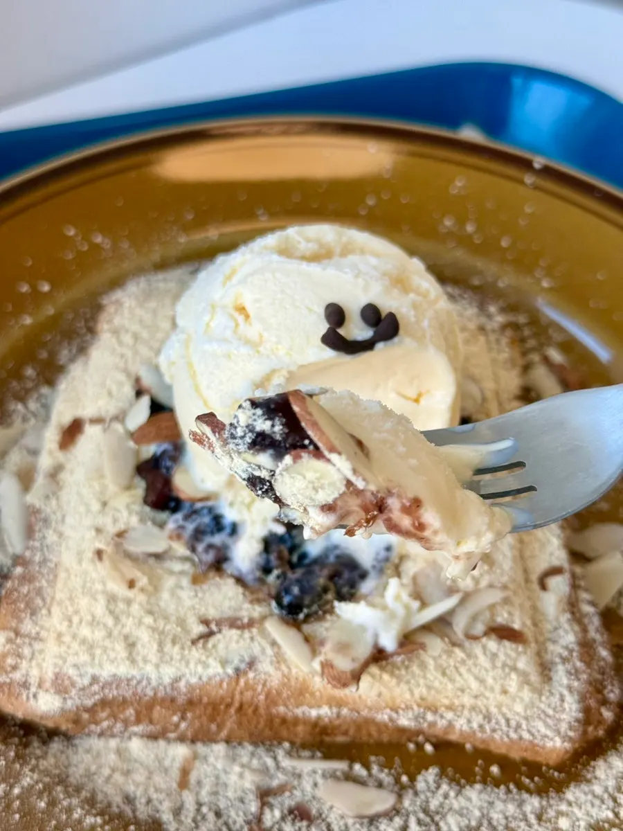Close-up of injeolmi toast topped with red bean and almonds