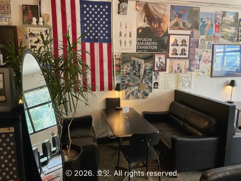 Hip seating area decorated with a full-length mirror and posters