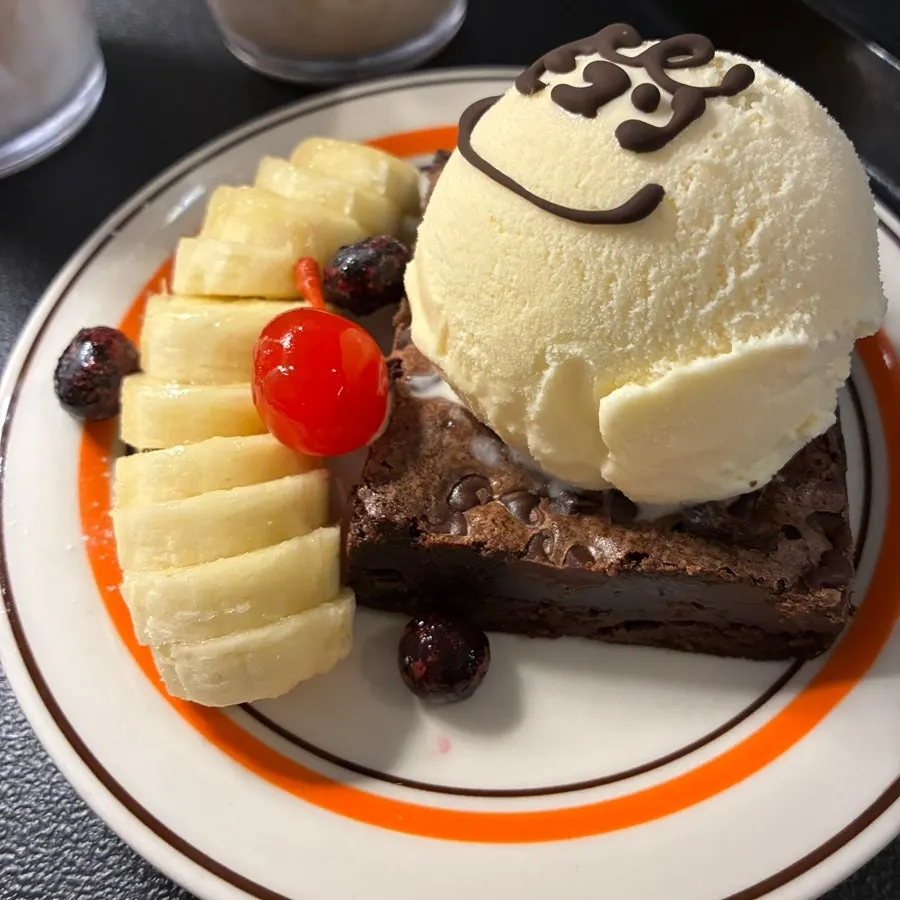 A plate with brownie and vanilla ice cream dessert