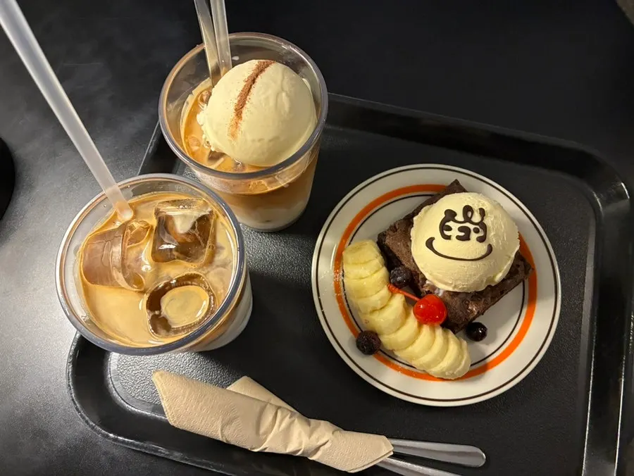 A café table with coffee and dessert set out