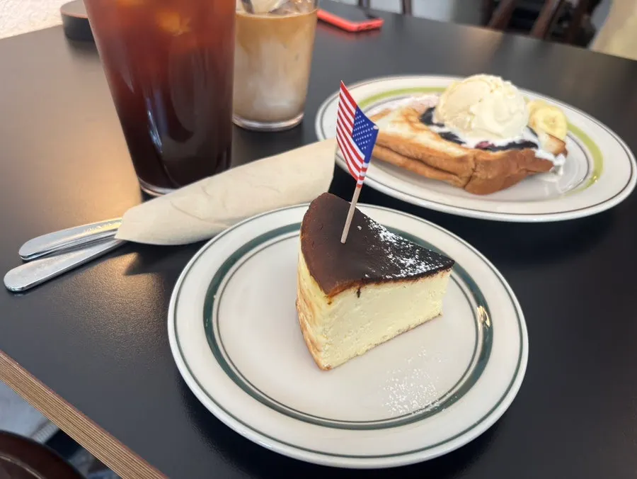 Cheesecake placed alongside coffee