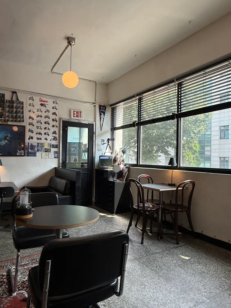 Spacious interior with tables arranged throughout the café