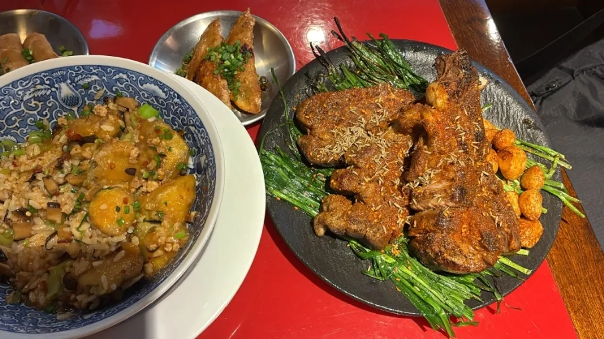 Table spread of Huhugwan's eggplant rice bowl and cumin lamb ribs