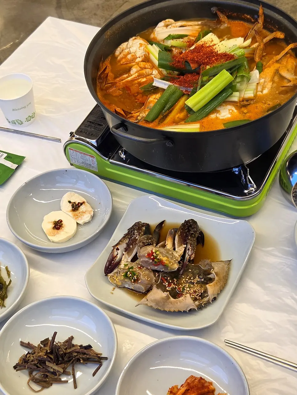Small-size authentic crab soup in a pot filling the burner