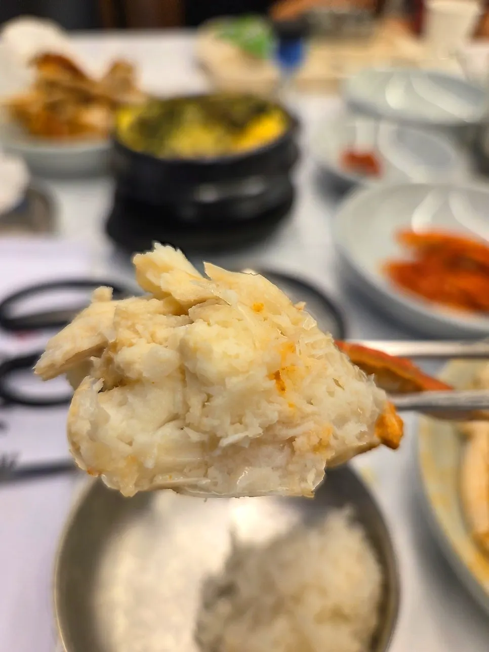 White crab meat piled on rice soaked in broth