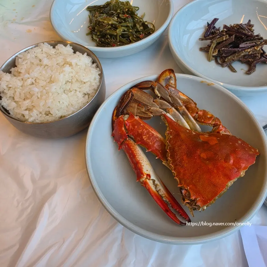 Crab meat picked out using scissors and tongs