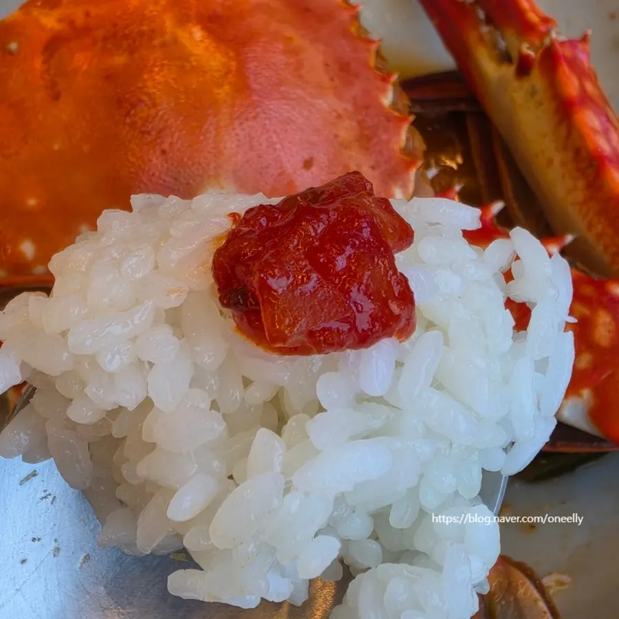 A spoonful of rice topped with crab meat
