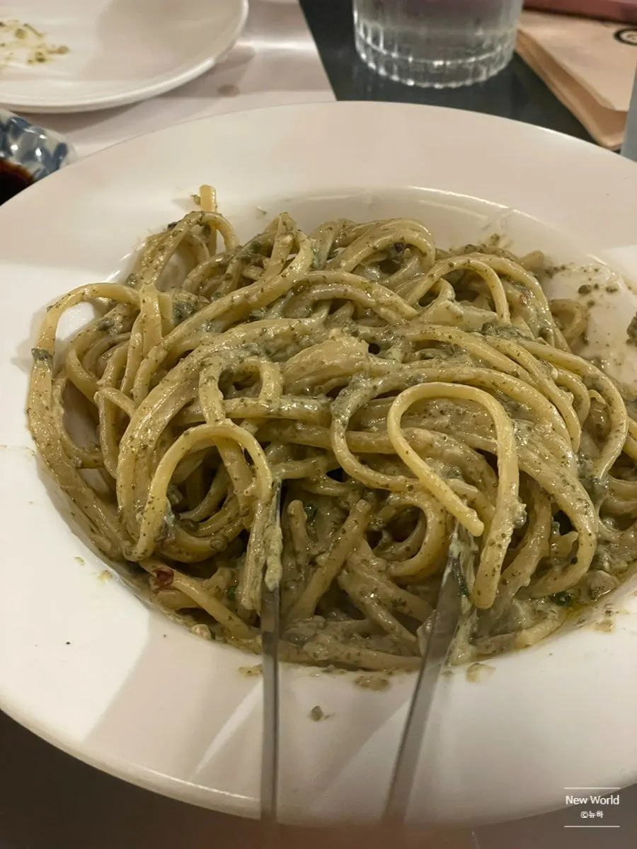 Chewy pieces of abalone visible in the pasta