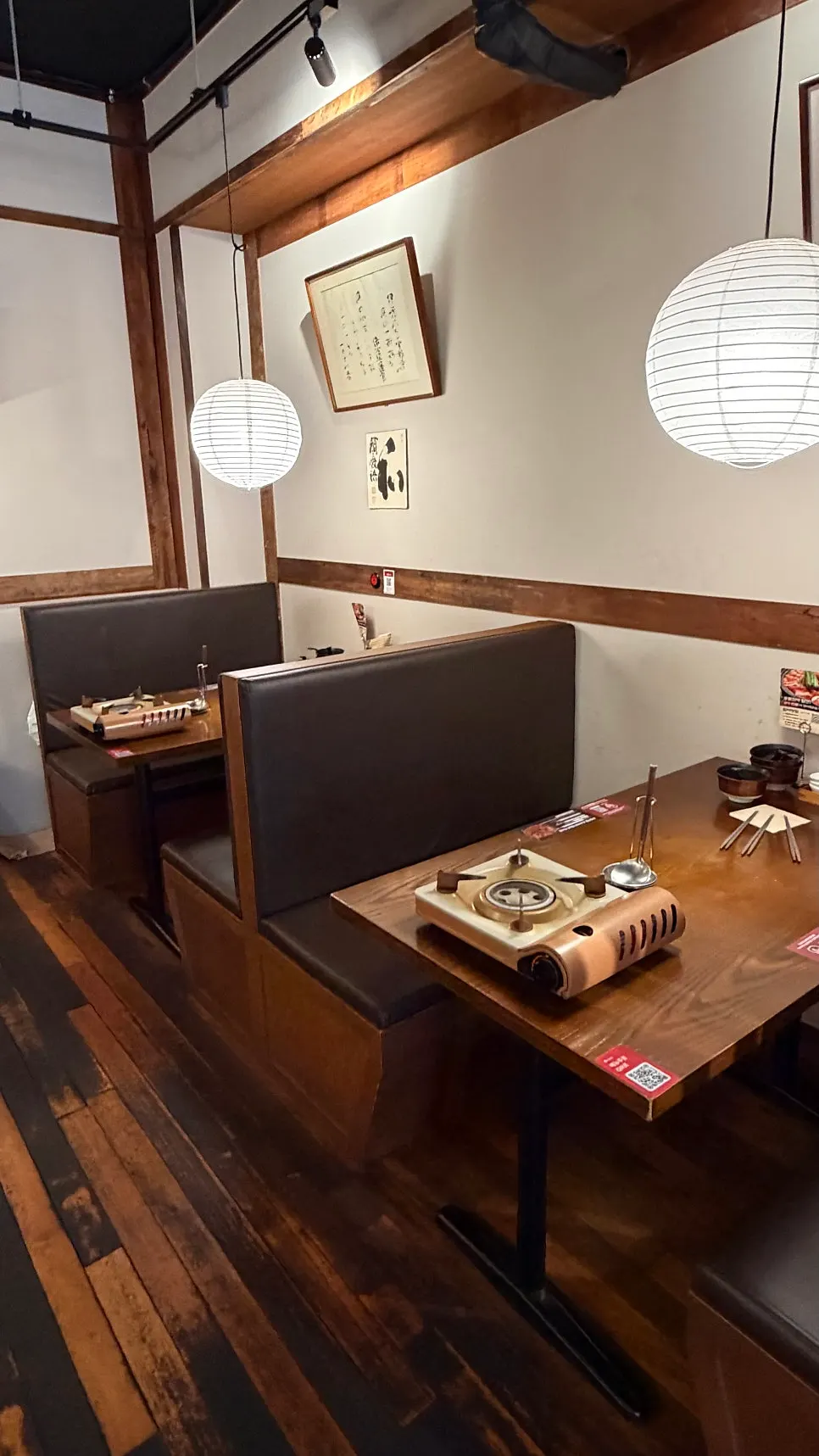 Interior of the restaurant with deep wood-tone, Japanese-style decor