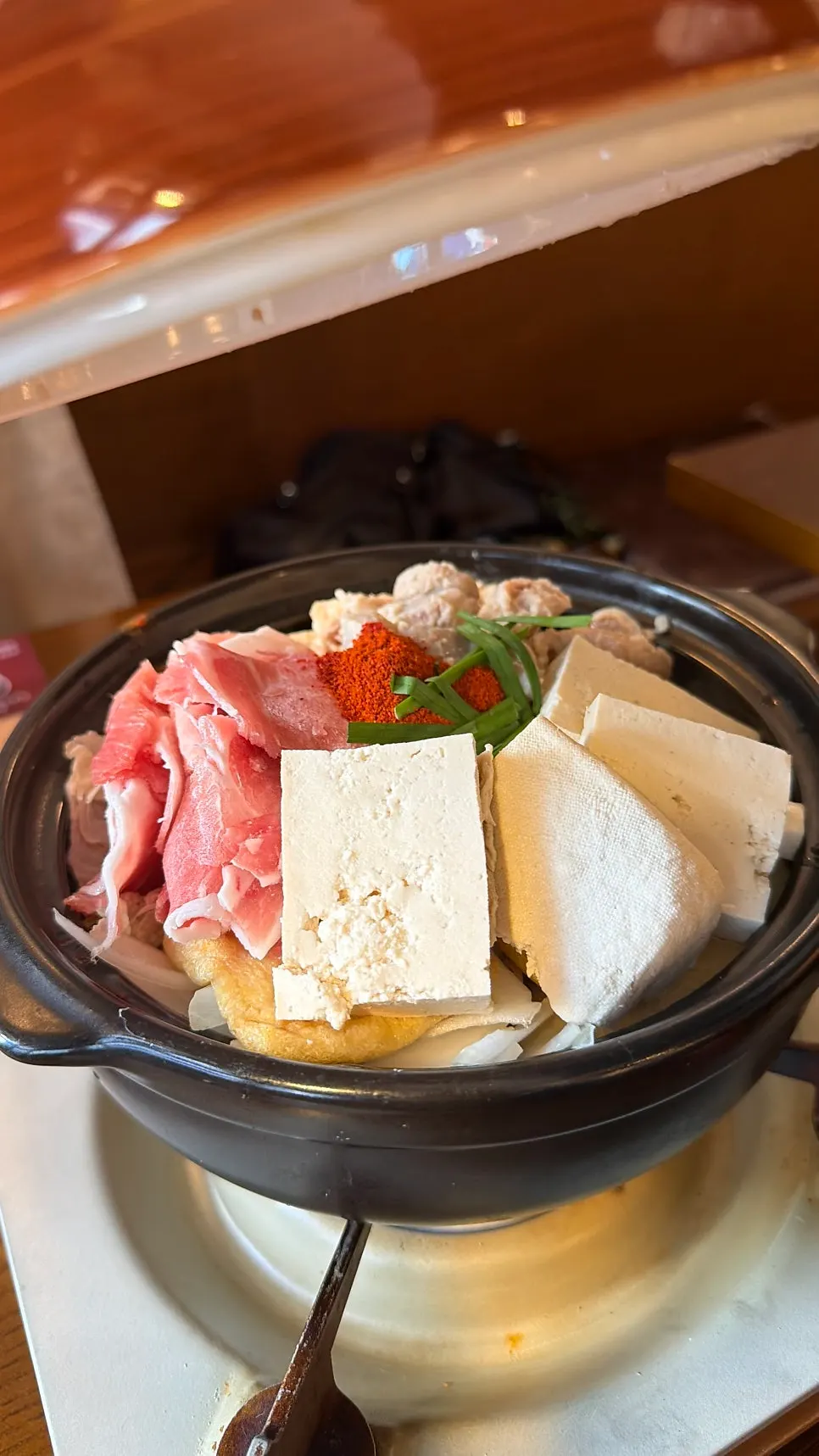 Pot of beef gopchang and daechang hot pot with tofu and mushrooms
